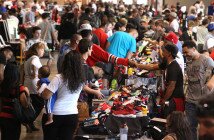 Jason Johnson of "Kicktown" shakes hands with Rich King (in red) of Columbus during the "Sneaker Freaks" shoe sale at the Rhodes Center on the Ohio State Fairgrounds in Columbus, Ohio on September 14, 2014. The Rhodes Center was hosting the second annual "Sneaker Freaks" Show Expo, an event where visitors and vendors barter over different high end sneakers. The event was founded by a local group who wanted to bring the concept of a Sneaker Expo home after seeing it's success in other cities. (Columbus Dispatch photo by Brooke LaValley)